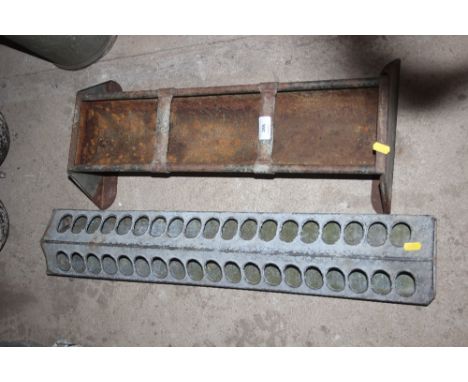 A small galvanised trough and a galvanised chicken feeding trough 