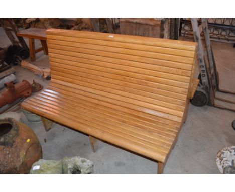 A large oak double sided slatted bench