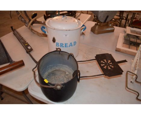 An enamel bread bin; cast iron pot and a chinmey trivet
