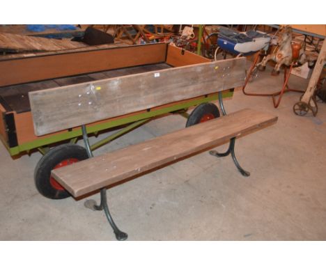 A large cast iron and wooden garden bench 
