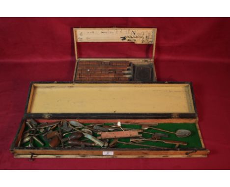 A tray of sculptors tools and a tray of wooden printing letters and numbers