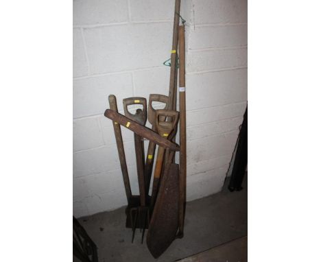 A quantity of long handled tools including hay knife, forks etc. 
