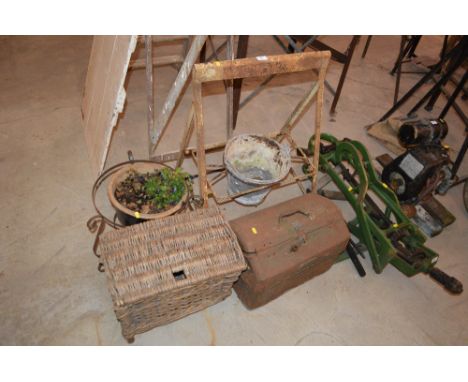 A folding metal bucket holder, metal toolbox, old fishing basket and a planter