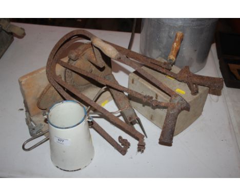 Three fret saws; a cake icer; a small enamel can; a meat slicer etc.