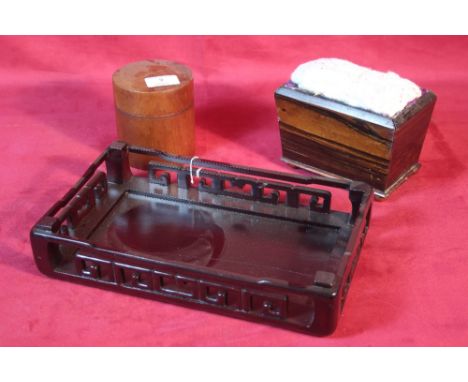A vintage rosewood pin cushion on brass bun feet; a hardwood oriental stand and a turned yew wood pot