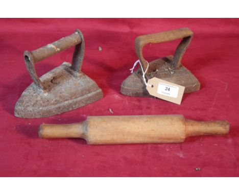 Two old flat irons and a wooden rolling pin