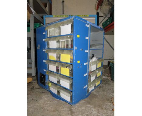 A ROTATING STORAGE CAROUSEL CONTAINING VARIOUS SYRINGES, ROTARY CUTTERS, BUTTONS ETC