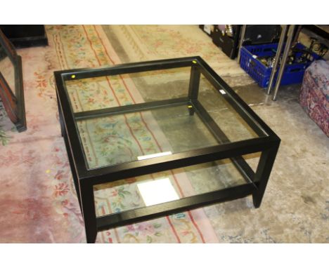 A MODERN GLASS TOPPED COFFEE TABLE