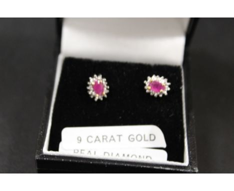 A PAIR OF A RUBY AND DIAMOND SET EARRINGS