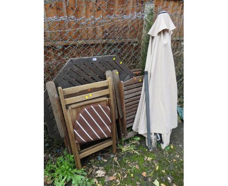 A TEAK PATIO TABLE WITH FOUR CHAIRS AND A PARASOL