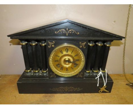 AN ANTIQUE BLACK SLATE MANTLE CLOCK 