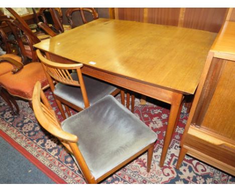 A MID CENTURY TEAK EXTENDING DINING TABLE AND FOUR CHAIRS