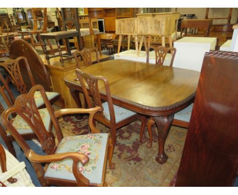 A LARGE EARLY 20TH CENTURY MAHOGANY SIDEBOARD, WIND-OUT DINING TABLE AND 7 CHAIRS ON BALL AND CLAW FEET