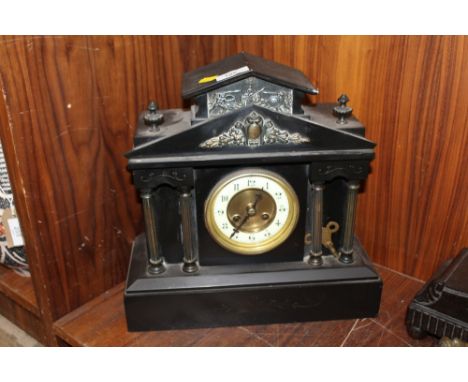 A FRENCH BLACK SLATE MANTLE CLOCK OF ARCHITECTURAL FORM