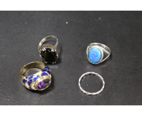 FOUR ASSORTED DRESS RINGS COMPRISING THREE SILVER EXAMPLES TOGETHER WITH A JOAN RIVERS GILT METAL ENAMEL AND GEMSET RING