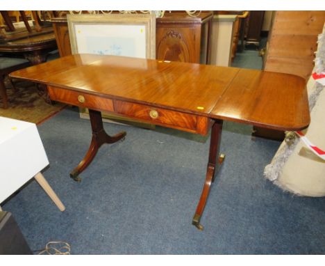 AN ANTIQUE MAHOGANY SOFA TABLE WITH BRASS CAPPINGS AND CASTORS