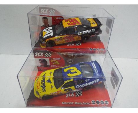 SCX - 2 x Slot Cars in 1:32 scale. # 64220 Chevrolet Impala SS Caterpillar and Chevrolet Monte Carlo. Vehicles appear mint in