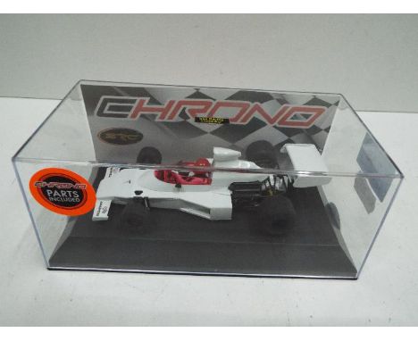 SCR Chrono model - Slot Car in 1:32 scale. # 52301 McLaren M23. Vehicle appears mint in perspex presentation cases. Light sto