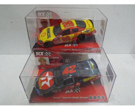 SCX - 2 x Slot Car in 1:32 scale. # 62670 Chevrolet Monte Carlo and # 63420 Dodge Charger Montoya. Vehicles appear mint in pe