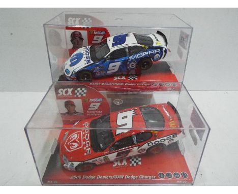 SCX - 2 x Slot Cars in 1:32 scale. # 63360 Dodge Charger Kahne and # 62200 2006 Dodge Charger. Vehicles appear mint in perspe