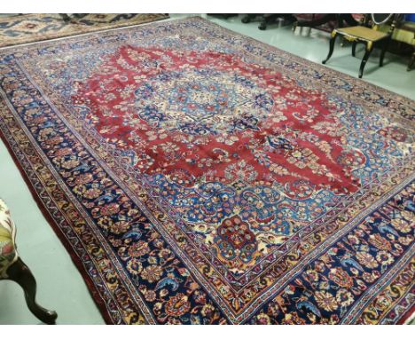Rich red ground Iranian Carpet of the Mashad Region, traditional floral medallion pattern (large sized), 3.9m x 2.92m