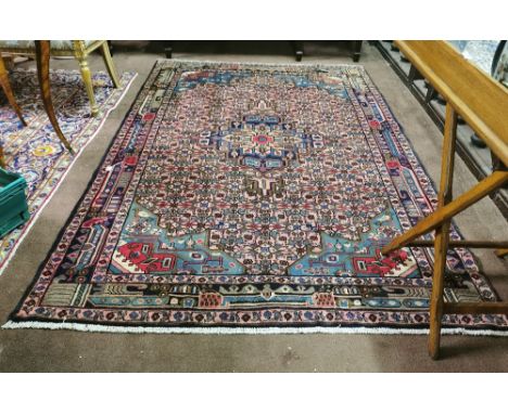 Washed light red ground Persian Carpet, Heriz region, floral pattern and central medallion, 2.44m x 1.57m
