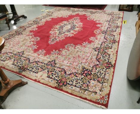Persian Wool Carpet, with a central medallion and multiple floral borders, red ground with light blue, dark blue and pink ton