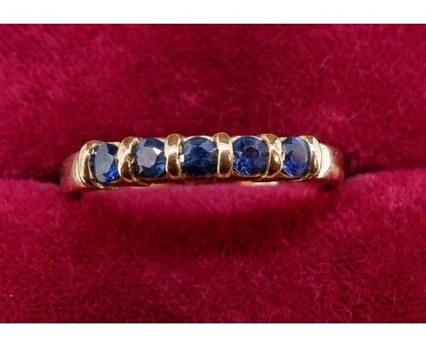 A 9 carat gold ring set five sapphires, size N 