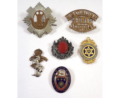 A group of badges including two cap badges, enamel nursing badge, masonic pendant and a Miracle brooch