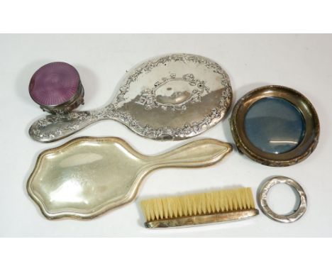 A circular silver photograph frame, two silver backed mirrors, small frame, silver and enamel trinket box a/f and a silver ba