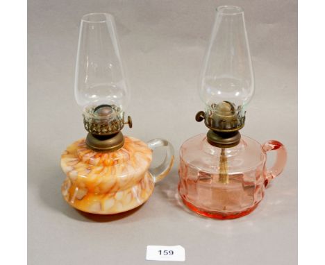 A Victorian mottled glass finger lamp and a pink glass one