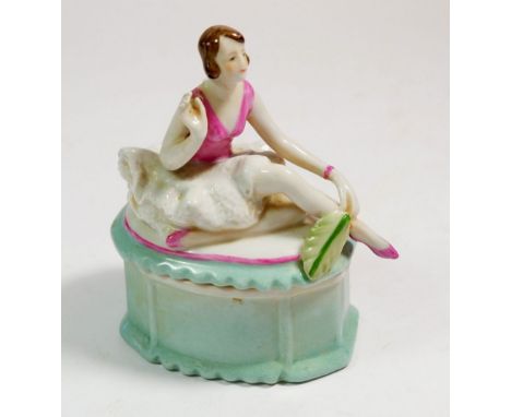 A German porcelain trinket box with seated dancer to lid, 11cm tall 