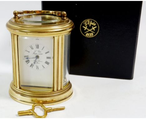 A L'Epee small brass carriage oval clock, cased, 7.5cm tall