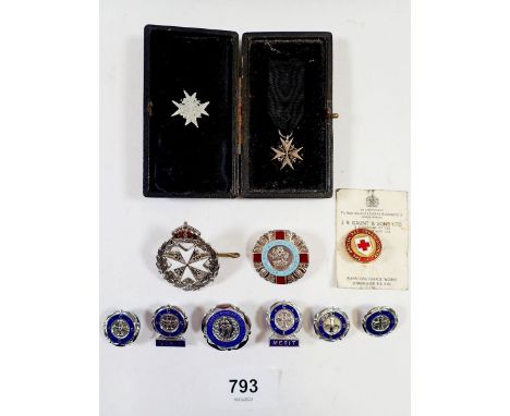 A miniature Red Cross medal cased with two other Red Cross badges, a General Nursing Council for England and Wales badge and 