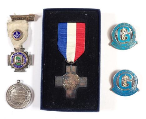 A silver General Service medal, two silver and enamel nursing medals and two other silver medals