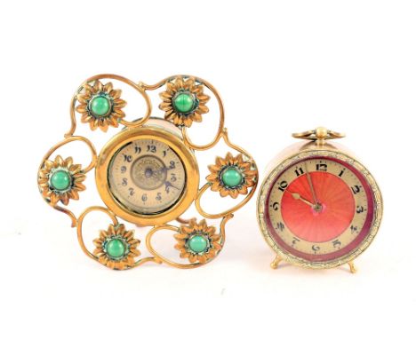 A brass easel clock set with green cabochon stones plus one other with red enamel dial