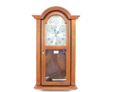 An oak cased Acctim Westminster chime wall clock