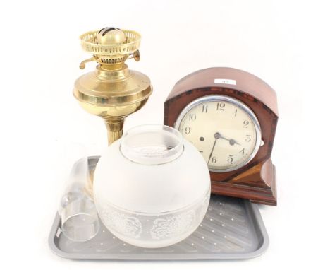 An inlaid mahogany mantel clock plus a brass oil lamp