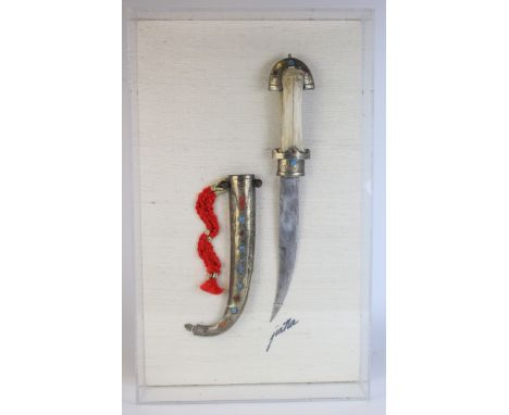 Arab Jambiya dagger (Blade 7.5") and silver covered scabbard mounted in a perspex case mounted on a hessian backing. 