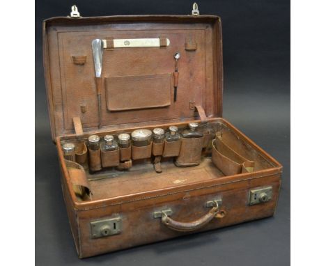 A 19th century leather rectangular travelling vanity case, the interior fitted with clear facetted Asprey jars, with silver c