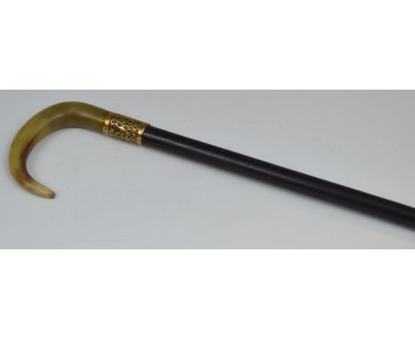 A Victorian walking stick, horn handle, gold plated collar embossed with scrolls, ebonised shaft, 83cm long, c.1860