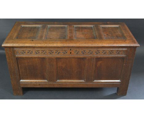 A 17th Century oak blanket box,with three panel front, the interior with candle box, 109cm wide, 54cm high, c.1720