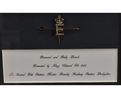 Royal Interest - an Edwardian 9ct gold, diamond and ruby presentation bar brooch, centred by the crowned royal cypher of Edwa