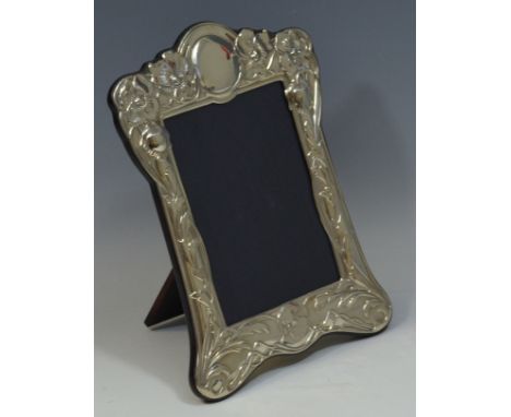A silver Art Nouveau style rectangular easel  photograph frame, embossed with flowers and sinuous stems, 22cm x 16cm, Sheffie
