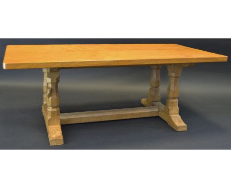 Robert Thompson, Mouseman of Kilburn - an oak coffee table, rounded rectangular adzed top, panelled baluster legs, sledge bas