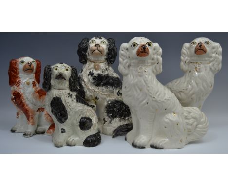 A pair of Victorian Staffordshire mantel dogs, standing to the left and right, light decorated in gilt with flecks black face