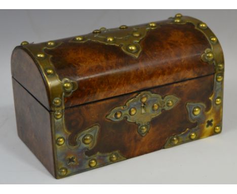 A Victorian walnut and brass mounted domed tea caddy, the cut card brass work with studs, the interior with two lidded compar