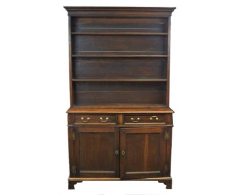 A 19th century oak side cabinet, the moulded cornice above three open shelves, the base fitted with two moulded drawers, fiel