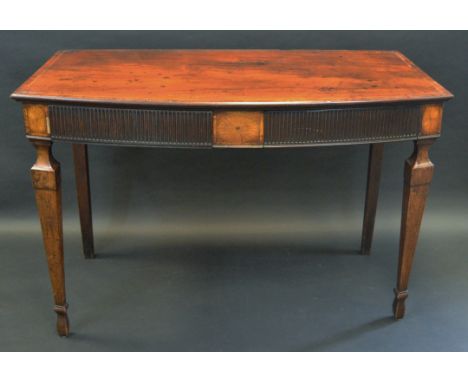 A George III mahogany serving table, slightly bowed top with deep frieze with two fluted drawers and flanked by  batwing pate