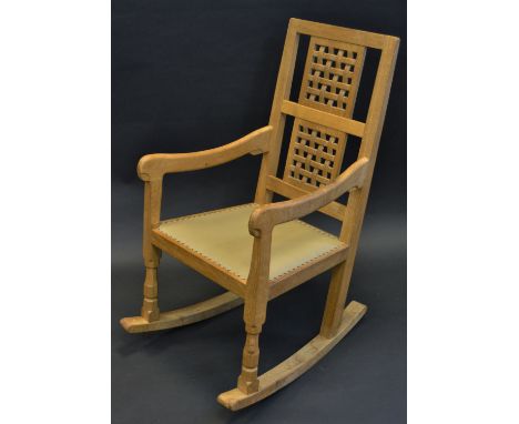 Robert Thompson, Mouseman of Kilburn - an oak rocking chair, rectangular back with two faux-woven panels, gently bowed arms, 